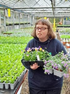 Horticap student holding bedding plants