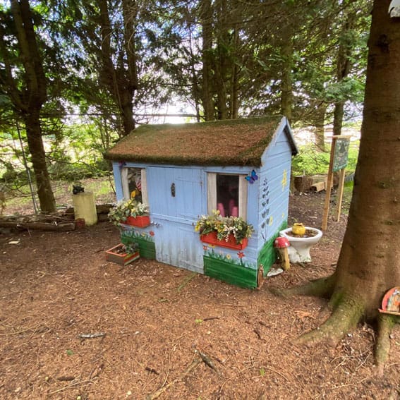 Wendy house surrounded by trees